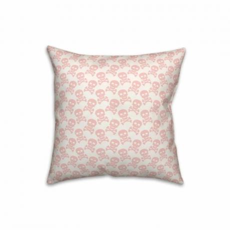 Un cuscino con teschio bianco e rosa