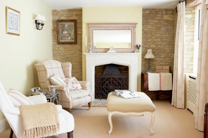 living_room_exposed_brick_cream_fireplace_footpool