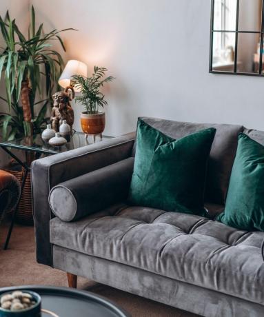 grå soffa med smaragdgröna kök och lampa