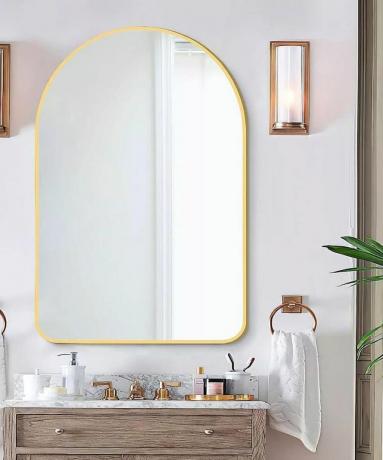 Um grande espelho oval em um banheiro