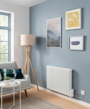 Světle modrý obývací pokoj s moderní stojací lampou a bílým radiátorem