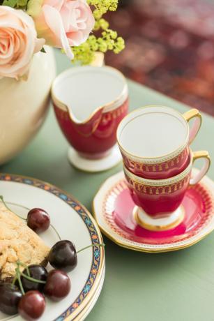 ชุดกาน้ำชาแดงบนโต๊ะพร้อมสโคน
