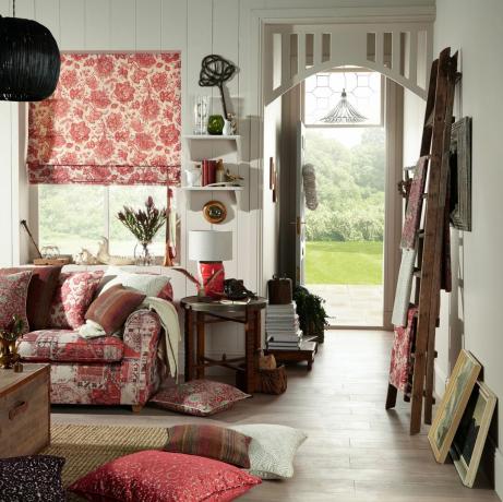 غرفة معيشة كوخ مع ستائر ملونة ووسائد وأريكة