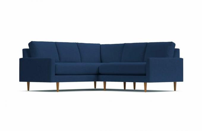 En marineblå L-formet sofa i fløjl