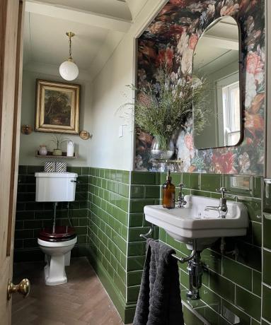 Zaļā vannas istaba ar ziedu tapetēm un Hannas Jangas svaigu zāles pušķi