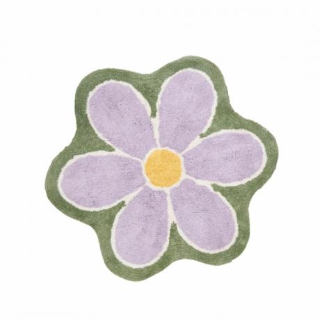 Et lilla blomstertæppe med en grøn kant