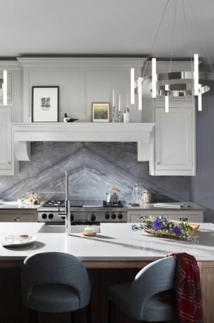 valkoinen shaker -tyylinen keittiö, jossa on kirjontaan asennetut graniittiset roiskeet ja keittiösaari
