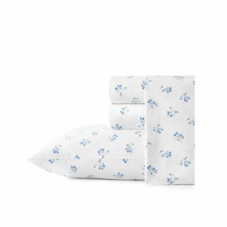 Un set di biancheria da letto bianco con fiori blu