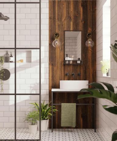 Una doccia con vetro doccia con cornice nera, box doccia piastrellato bianco metro
