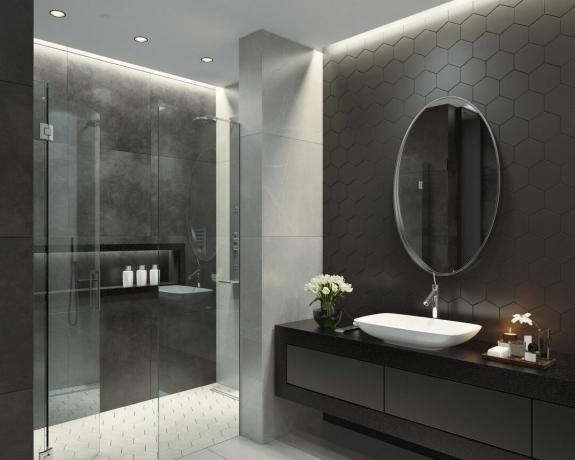 Svart badrum med handfat och spegel