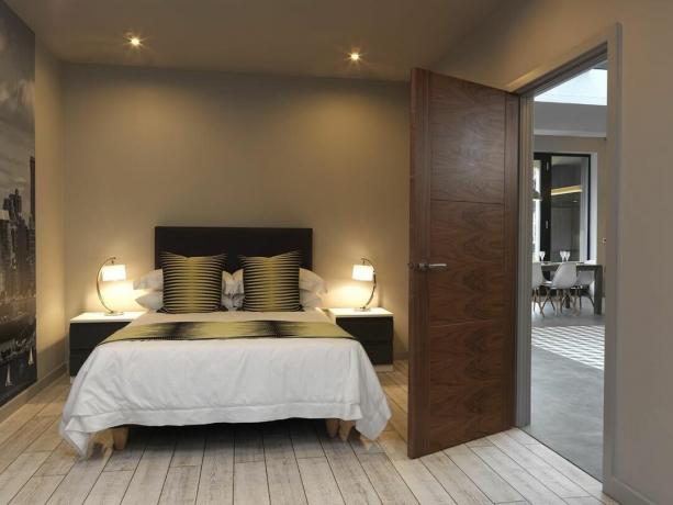 חדר שינה עם דלת אגוז מאת JB Kinds