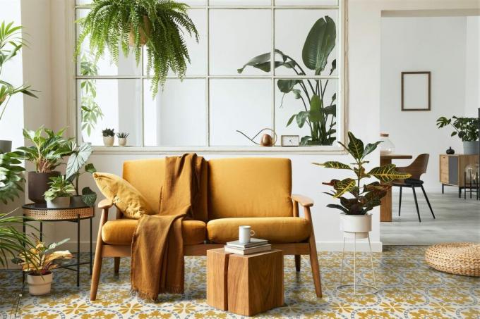 sončna soba s sivimi in rumenimi talnimi ploščicami z vzorcem in rumenim kavčem
